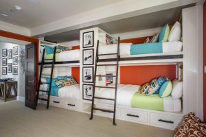A room with bunk beds and stairs in it