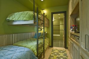A room with bunk beds and green walls
