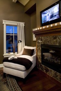 A room with a fireplace and television in it
