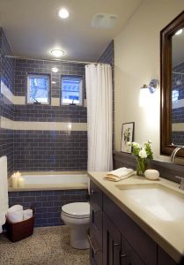 A bathroom with blue tiles and white walls