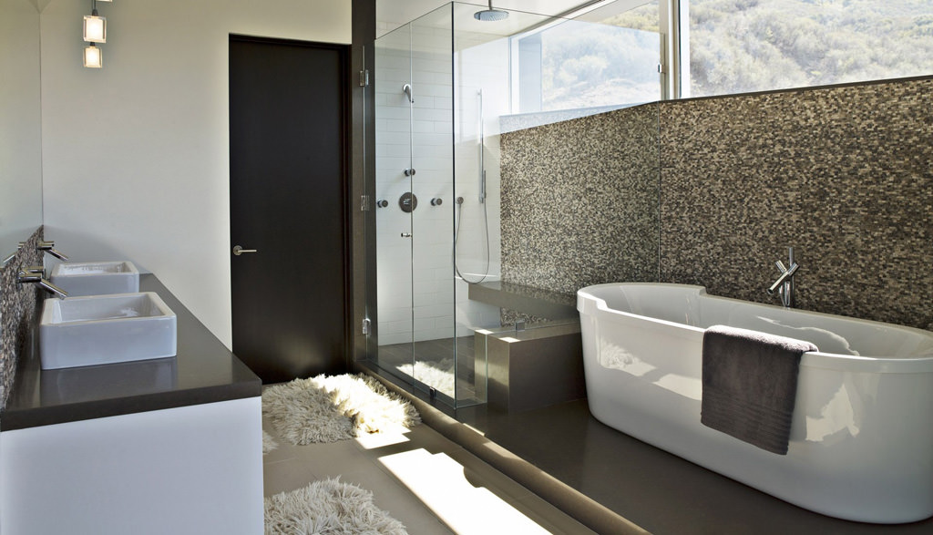 A bathroom with a tub and shower in it